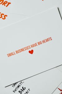Card with 'Small Businesses Have Big Hearts' message in orange lettering on white background.